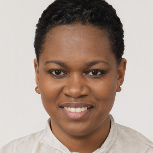 Joyful black young-adult female with short  brown hair and brown eyes