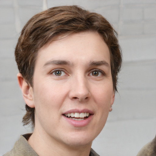 Joyful white young-adult male with medium  brown hair and grey eyes