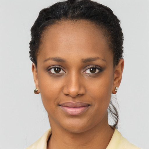 Joyful black young-adult female with short  black hair and brown eyes