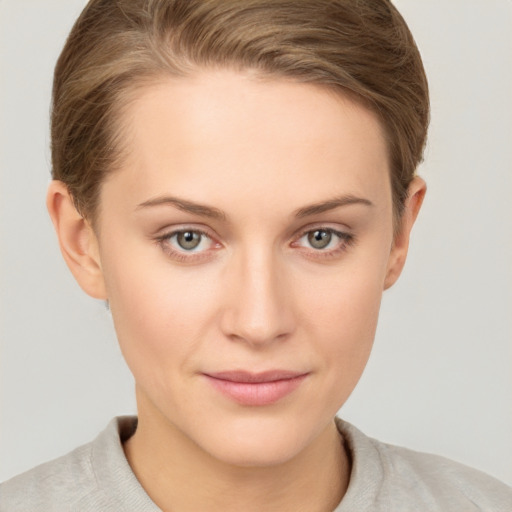 Joyful white young-adult female with short  brown hair and grey eyes