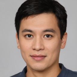 Joyful asian young-adult male with short  black hair and brown eyes