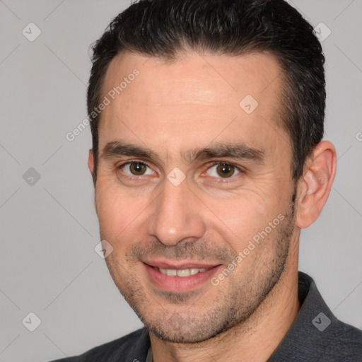 Joyful white adult male with short  brown hair and brown eyes