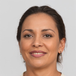 Joyful white adult female with medium  brown hair and brown eyes