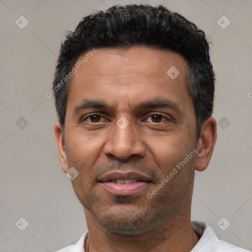 Joyful latino adult male with short  black hair and brown eyes