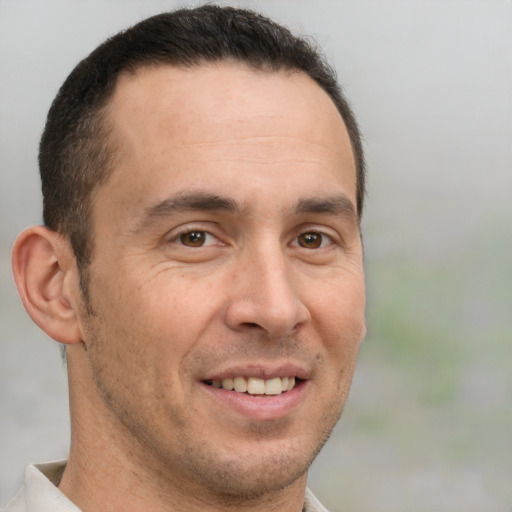 Joyful white adult male with short  brown hair and brown eyes