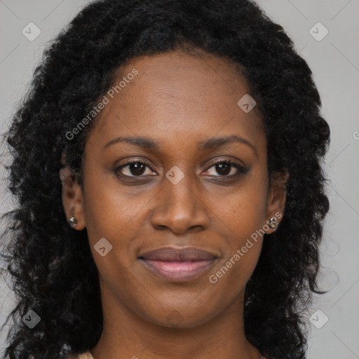 Joyful black young-adult female with long  brown hair and brown eyes