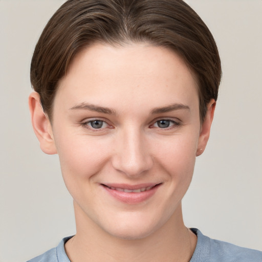 Joyful white young-adult female with short  brown hair and grey eyes