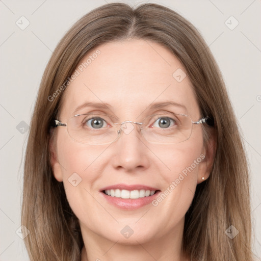 Joyful white adult female with long  brown hair and grey eyes