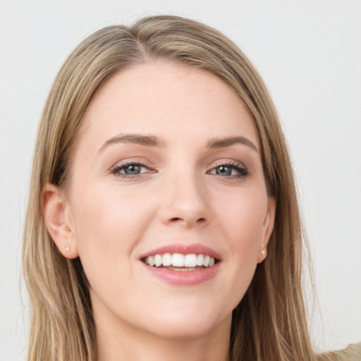 Joyful white young-adult female with long  brown hair and green eyes