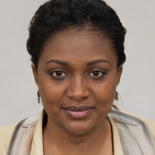 Joyful black young-adult female with short  brown hair and brown eyes