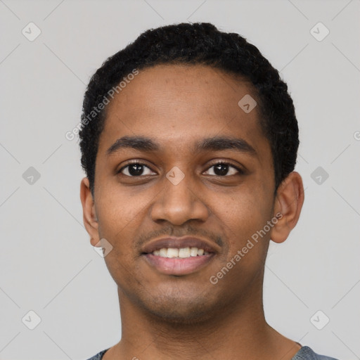 Joyful black young-adult male with short  black hair and brown eyes