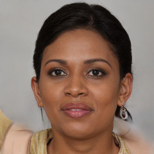 Joyful black young-adult female with medium  brown hair and brown eyes