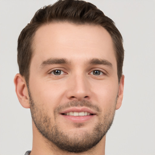 Joyful white young-adult male with short  brown hair and brown eyes