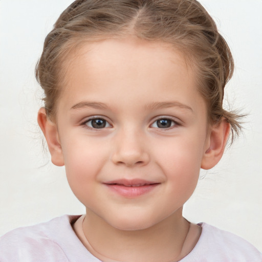 Joyful white child female with short  brown hair and brown eyes