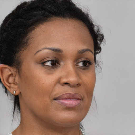 Joyful black young-adult female with medium  brown hair and brown eyes