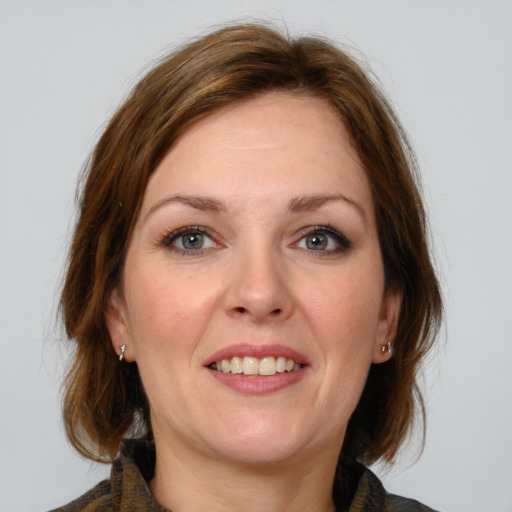 Joyful white young-adult female with medium  brown hair and blue eyes