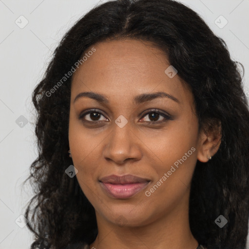 Joyful black young-adult female with long  brown hair and brown eyes