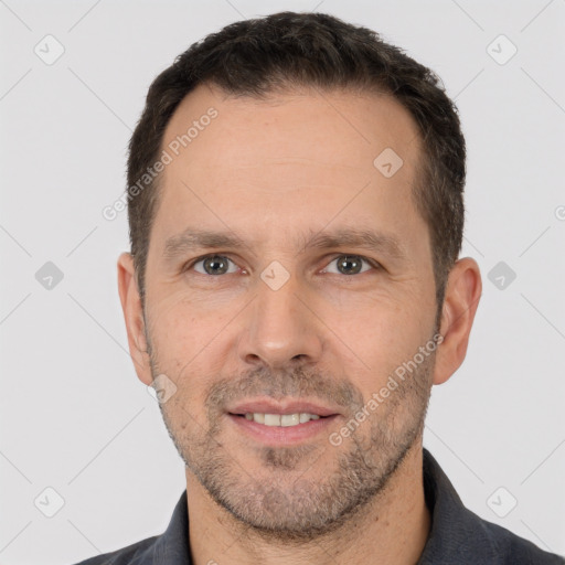 Joyful white adult male with short  brown hair and brown eyes