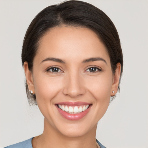 Joyful white young-adult female with medium  brown hair and brown eyes