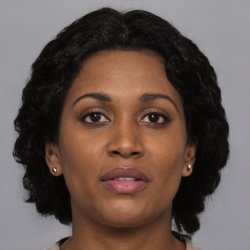 Joyful black young-adult female with medium  black hair and brown eyes