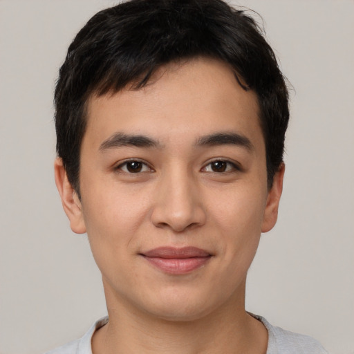 Joyful asian young-adult male with short  brown hair and brown eyes