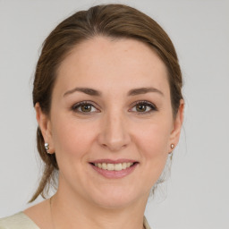 Joyful white young-adult female with medium  brown hair and grey eyes