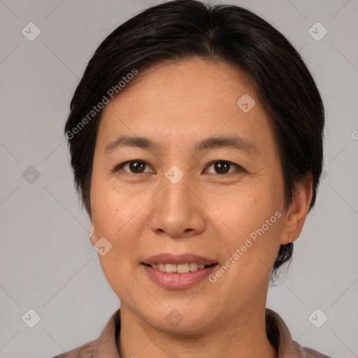 Joyful asian adult female with short  brown hair and brown eyes