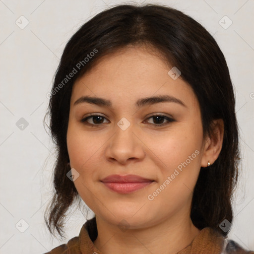 Joyful latino young-adult female with medium  brown hair and brown eyes