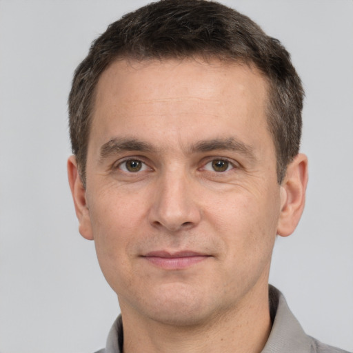 Joyful white adult male with short  brown hair and brown eyes