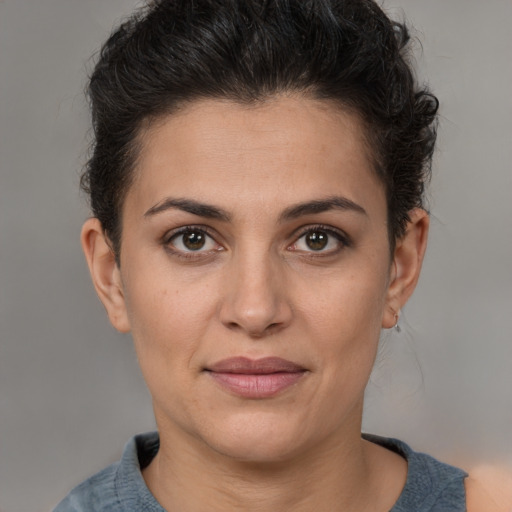 Joyful white adult female with short  brown hair and brown eyes