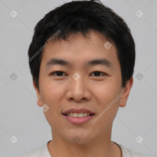 Joyful asian young-adult male with short  black hair and brown eyes