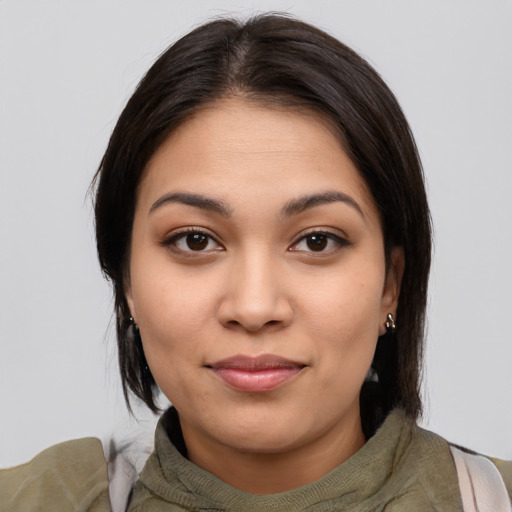 Joyful latino young-adult female with medium  brown hair and brown eyes