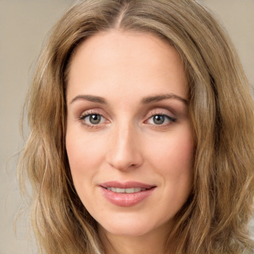 Joyful white young-adult female with long  brown hair and green eyes