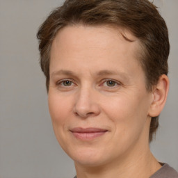 Joyful white adult female with short  brown hair and brown eyes