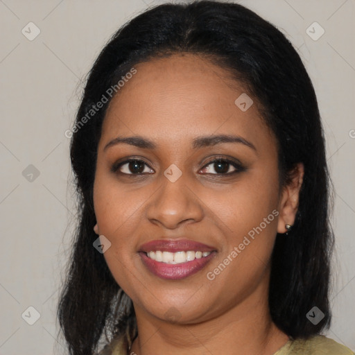 Joyful black young-adult female with long  black hair and brown eyes