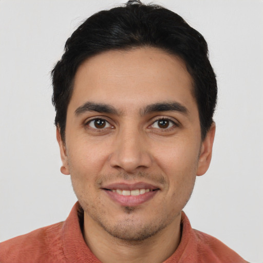 Joyful latino young-adult male with short  brown hair and brown eyes