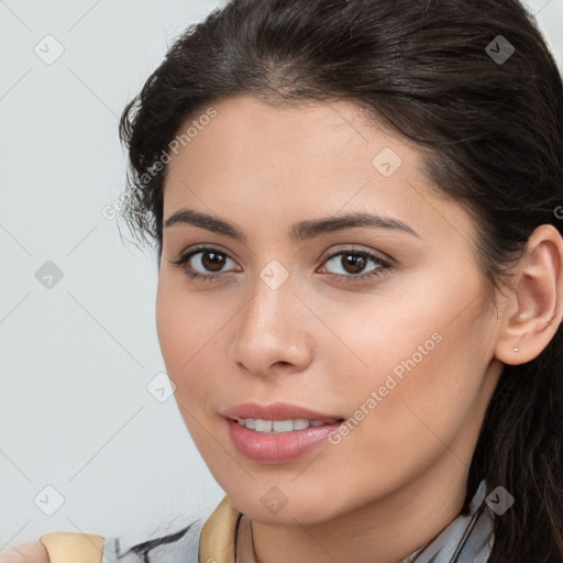 Joyful white young-adult female with long  brown hair and brown eyes