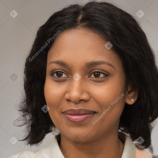 Joyful black young-adult female with long  black hair and brown eyes