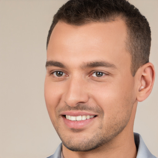 Joyful white young-adult male with short  brown hair and brown eyes