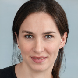 Joyful white young-adult female with medium  brown hair and blue eyes