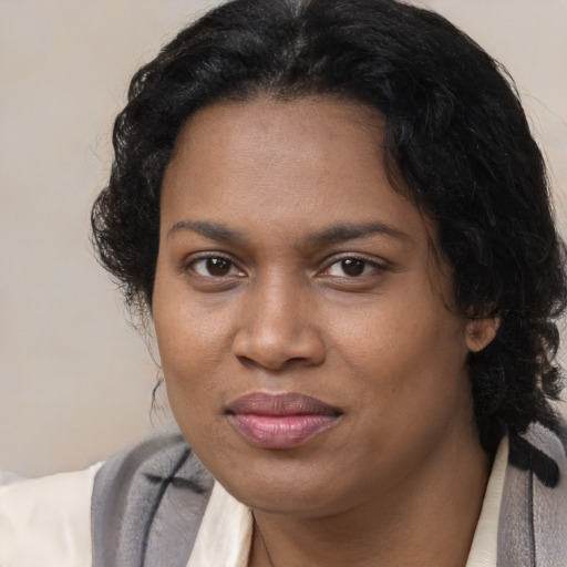 Joyful black young-adult female with medium  brown hair and brown eyes