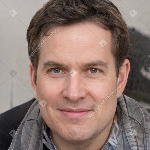 Joyful white adult male with short  brown hair and grey eyes