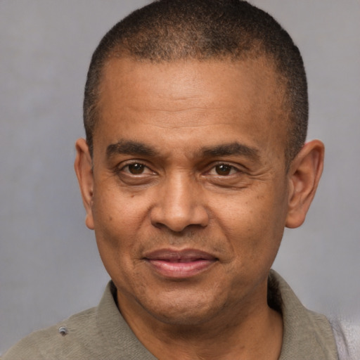 Joyful latino adult male with short  brown hair and brown eyes