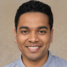 Joyful latino young-adult male with short  black hair and brown eyes