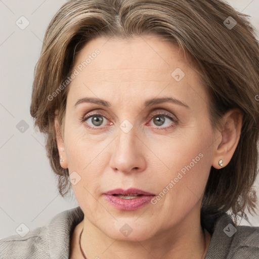 Joyful white adult female with medium  brown hair and grey eyes