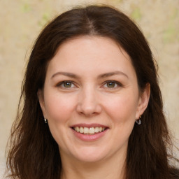 Joyful white young-adult female with long  brown hair and green eyes