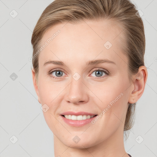 Joyful white young-adult female with medium  brown hair and blue eyes