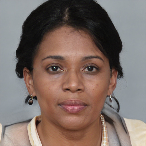 Joyful black adult female with medium  brown hair and brown eyes