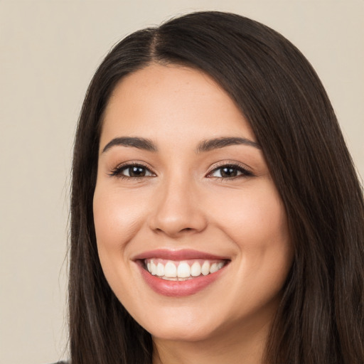 Joyful white young-adult female with long  brown hair and brown eyes