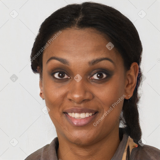 Joyful black young-adult female with long  brown hair and brown eyes